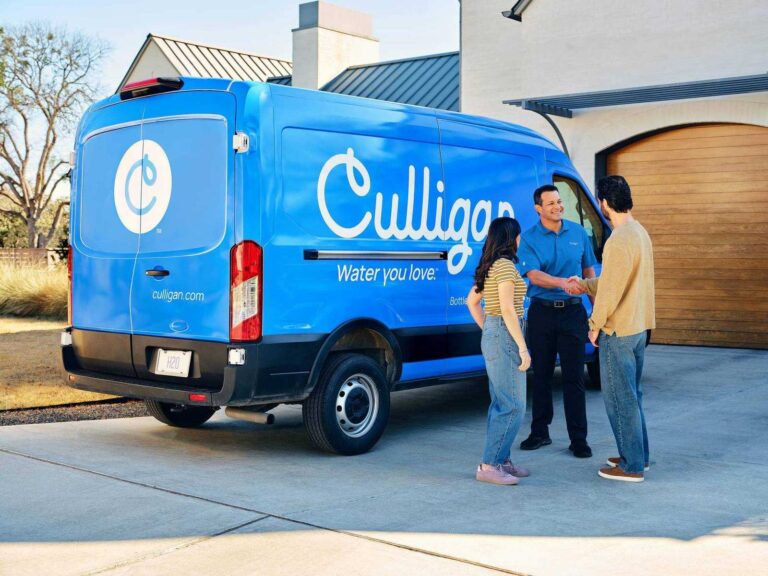 Culligan Man Shaking Hand Couple In Driveway